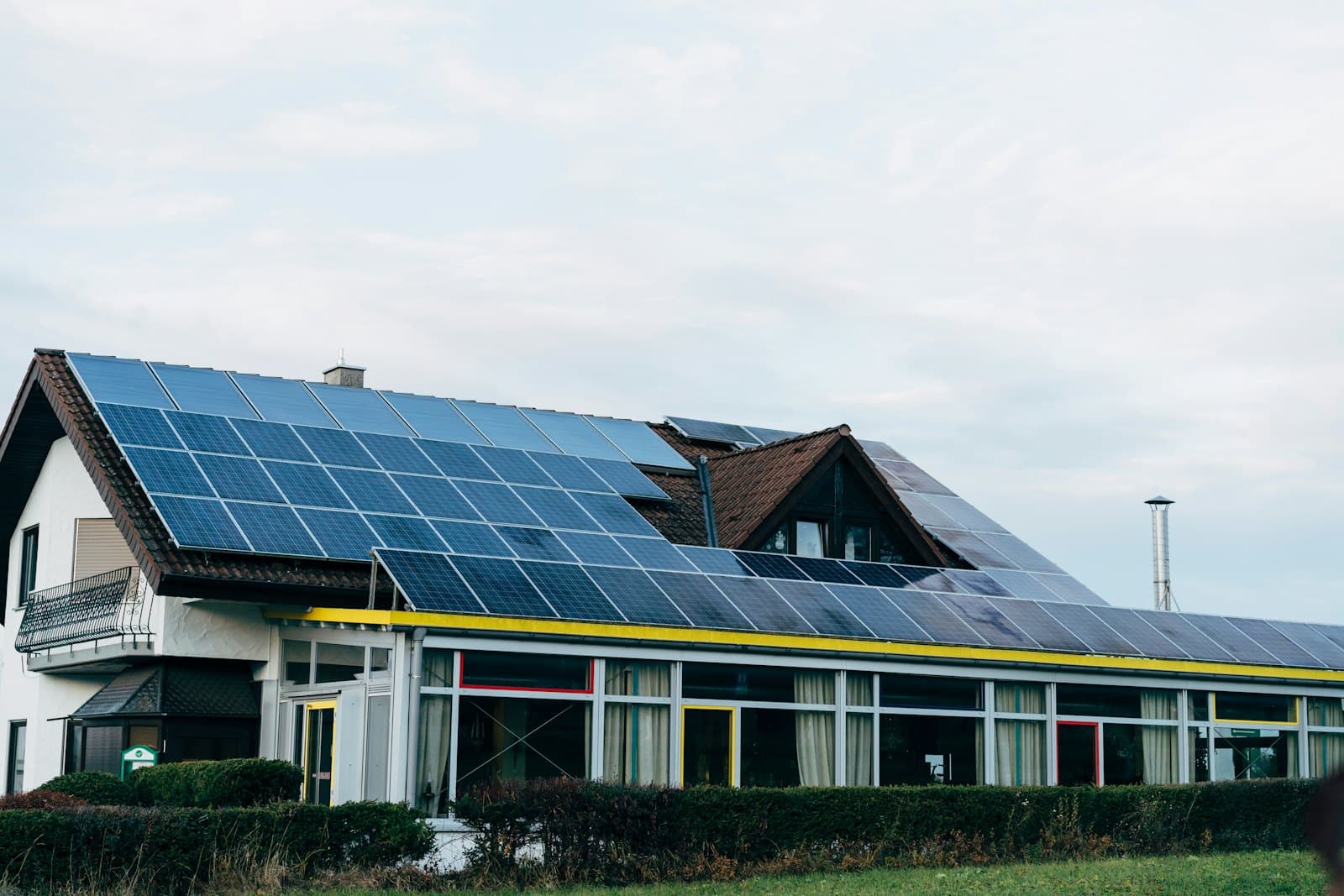 House with solar panels on the roof—we clean residential roof and ground-mounted systems