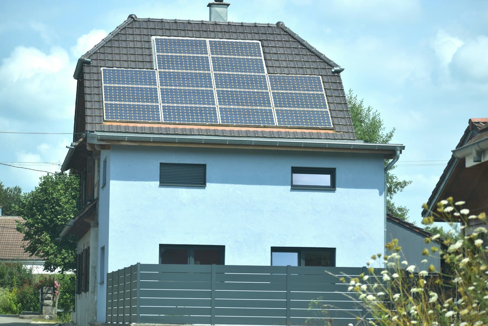 Home with solar panels on the roof—professional residential panel cleaning